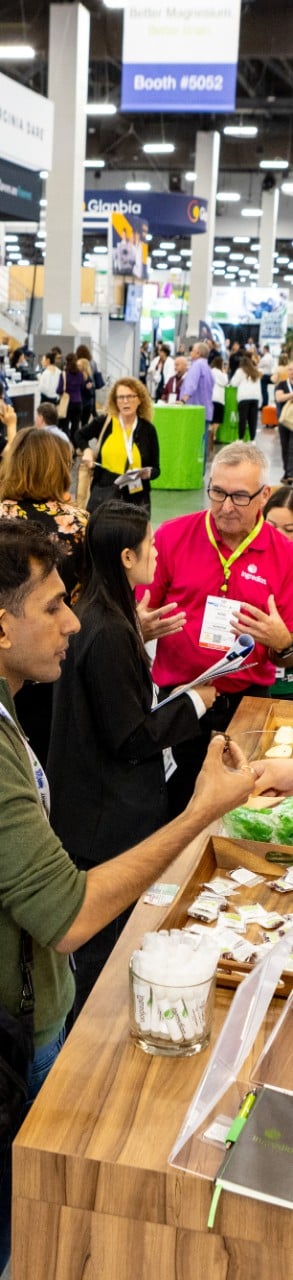 Expo floor with booths and industry professionals